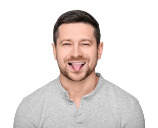 Photo of Happy man showing his tongue on white background