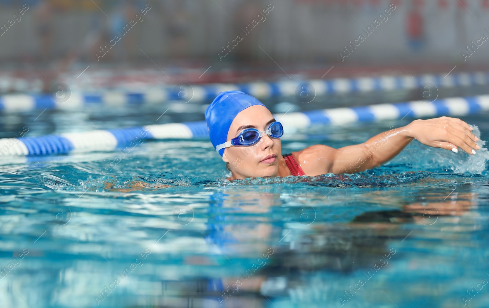 Photo of Young athletic woman swimming in pool