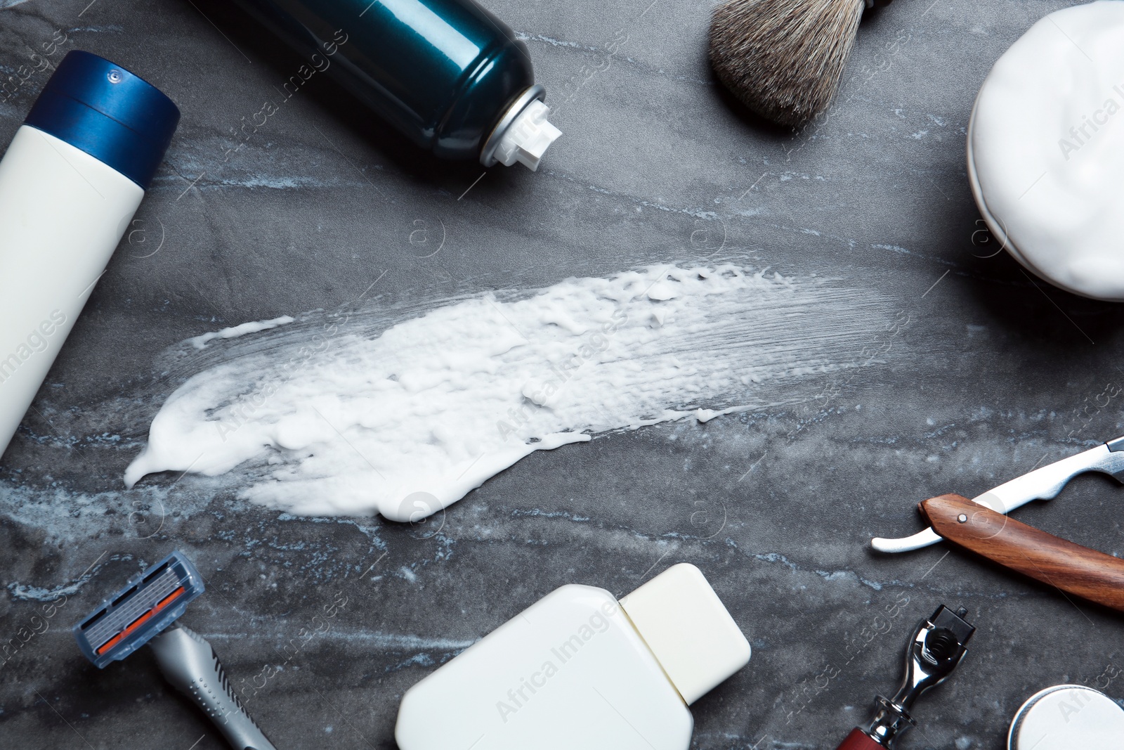 Photo of Flat lay composition with shaving accessories and foam stroke on gray background