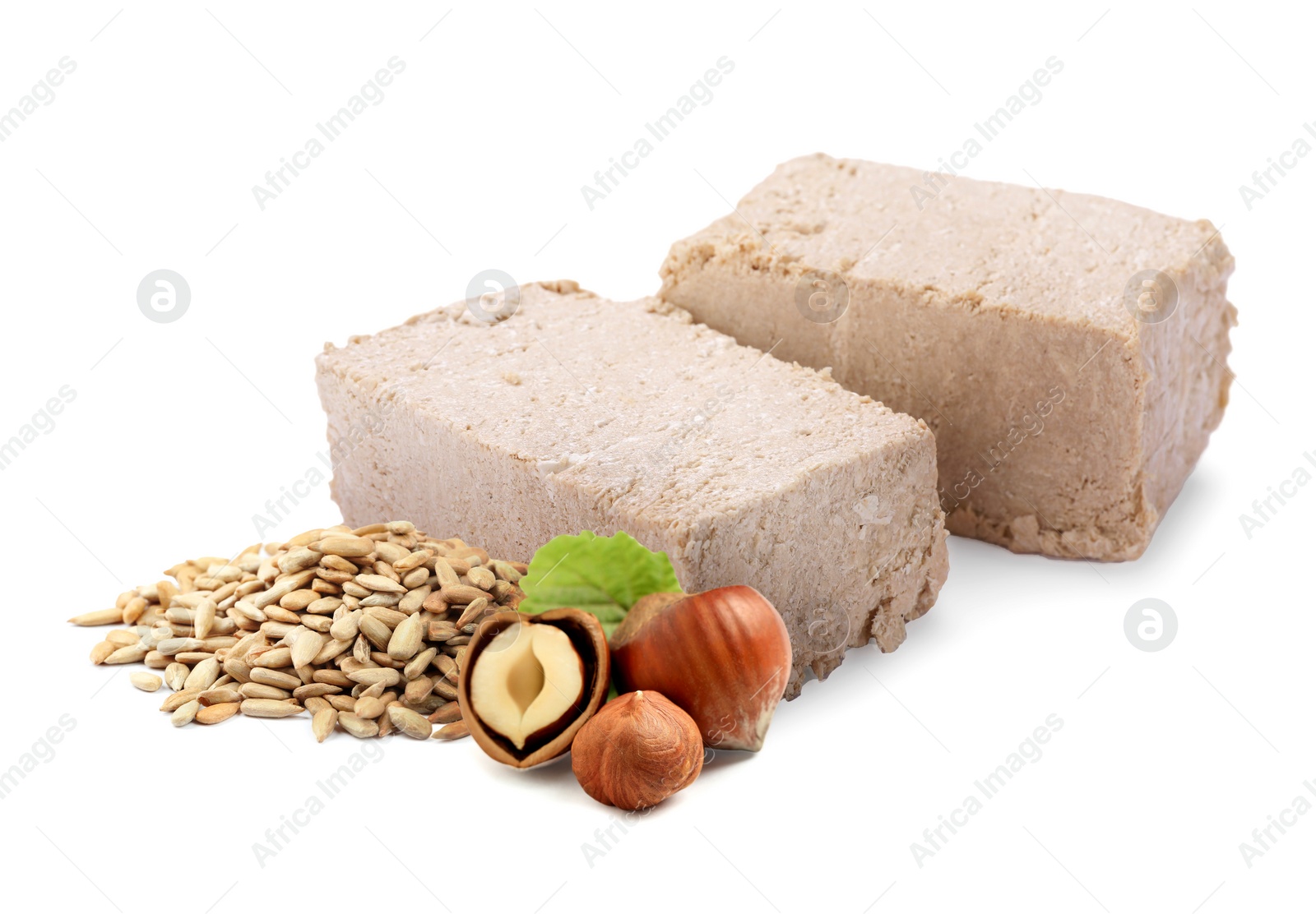 Image of Tasty halva, peeled sunflower seeds and hazelnuts isolated on white