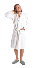 Young man in bathrobe on white background