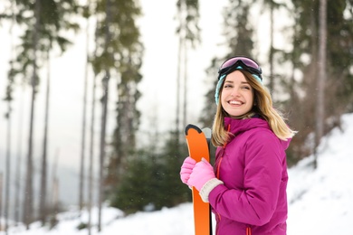 Photo of Female skier on slope at resort, space for text. Winter vacation