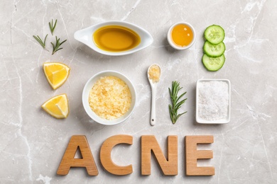 Word "Acne" and fresh ingredients for homemade problem skin remedy on light background