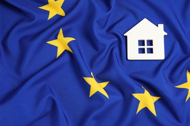 Photo of House model on flag of European Union, top view. Space for text