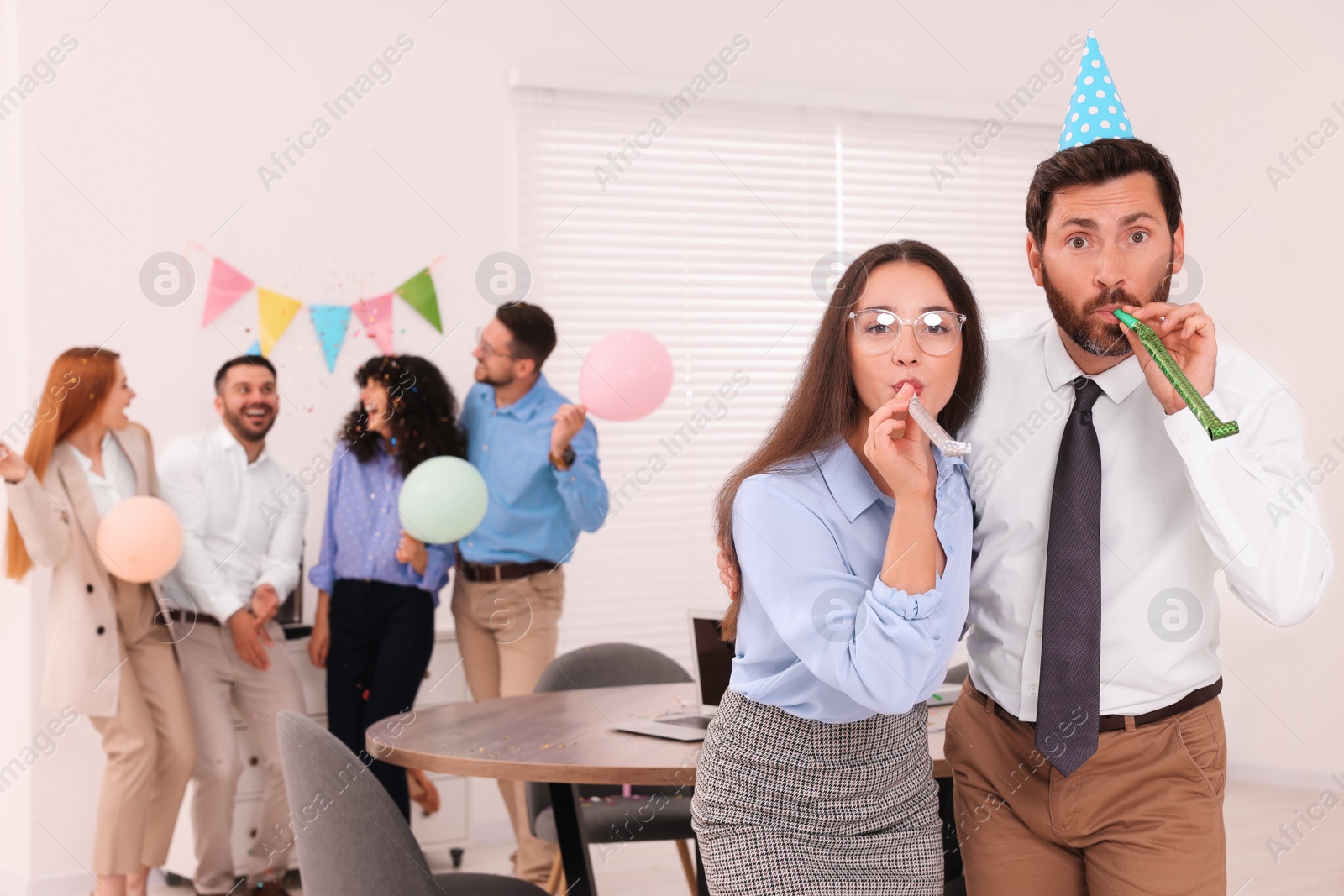 Photo of Coworkers having fun during office party indoors