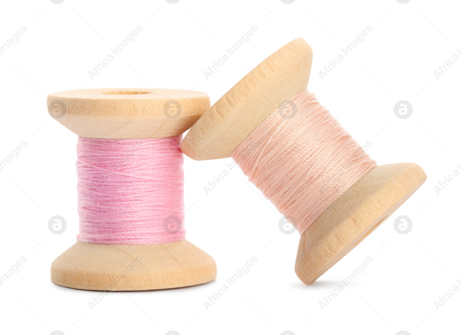 Photo of Different colorful sewing threads on white background, closeup