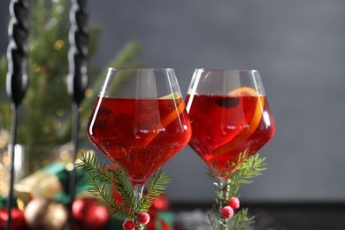 Photo of Christmas Sangria cocktail in glasses on blurred background, closeup