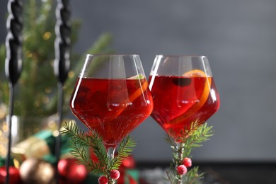 Christmas Sangria cocktail in glasses on blurred background, closeup