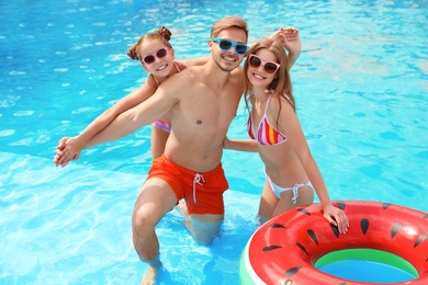 Photo of Happy family in pool on sunny day