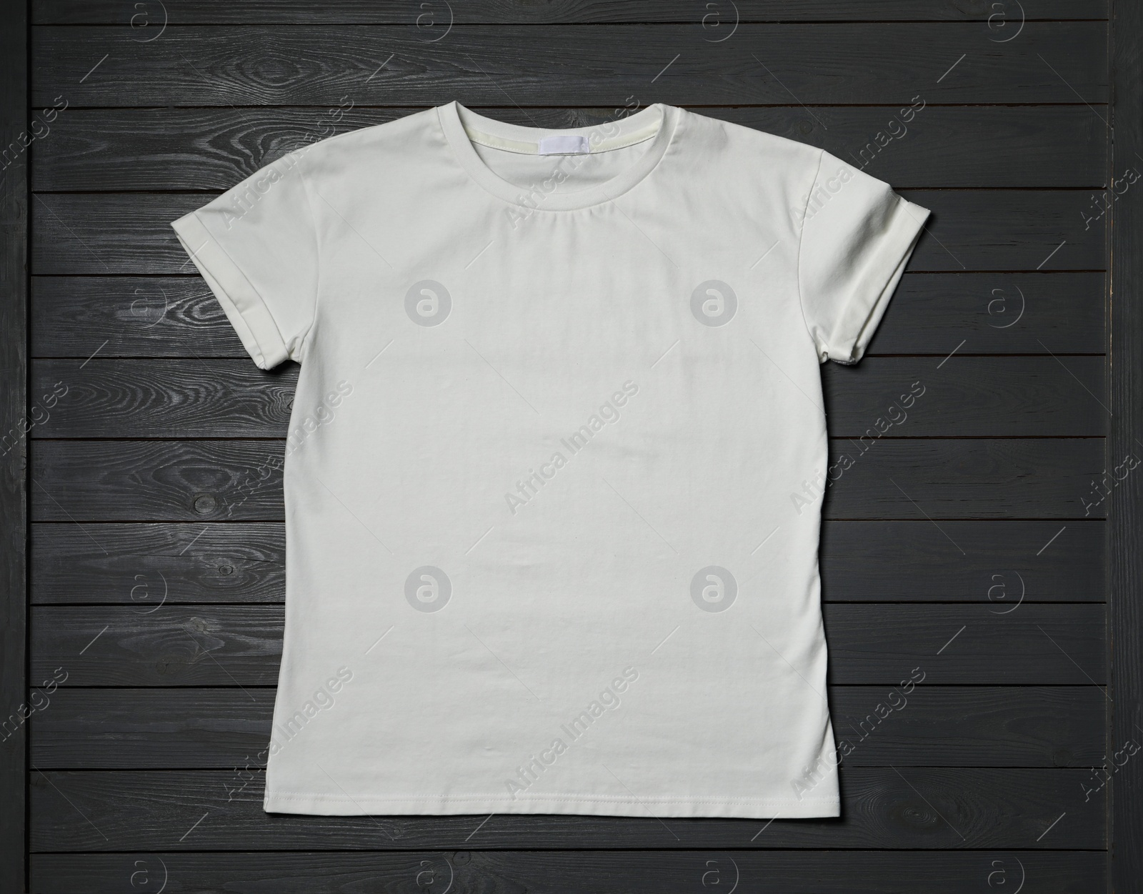 Photo of Stylish white T-shirt on gray wooden table, top view