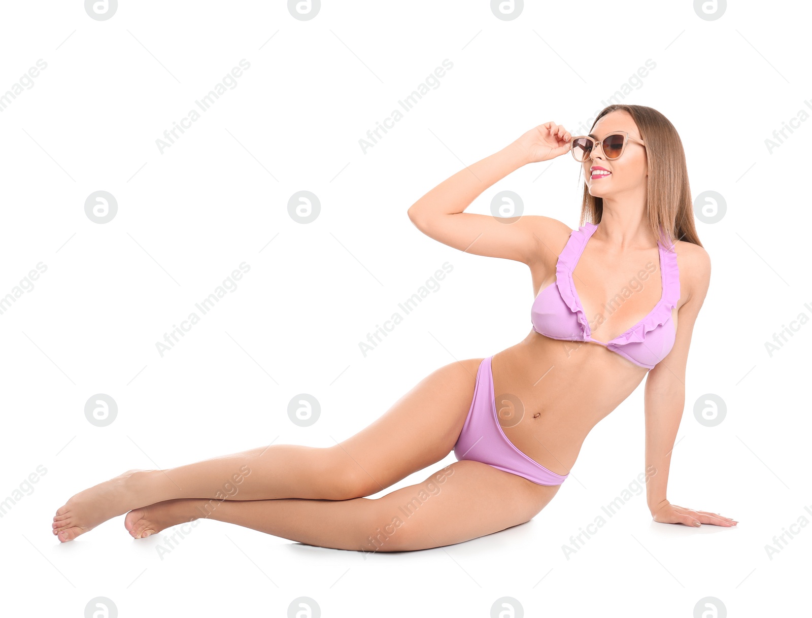 Photo of Pretty sexy woman with beautiful slim body in stylish bikini sitting on white background
