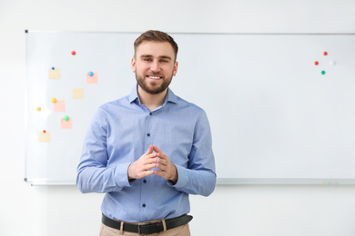 Photo of Portrait of young teacher near whiteboard in classroom