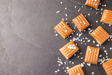 Salted caramel on grey table, flat lay. Space for text