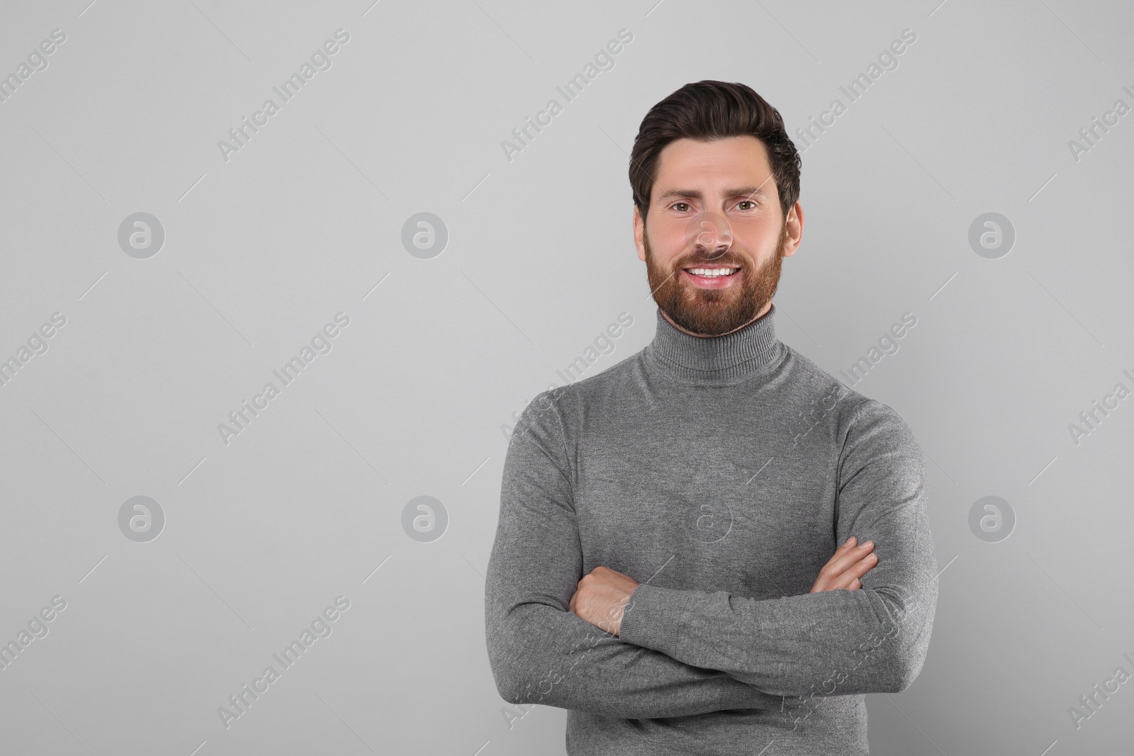 Photo of Portrait of handsome man on light grey background, space for text