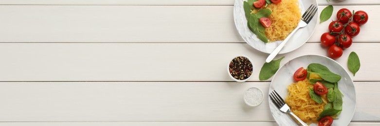 Tasty spaghetti squash with tomatoes and basil served on white wooden table, flat lay. Banner design with space for text
