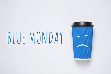 Image of Takeaway cup and text Blue Monday on white background, top view 