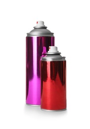 Photo of Different cans of spray paints on white background