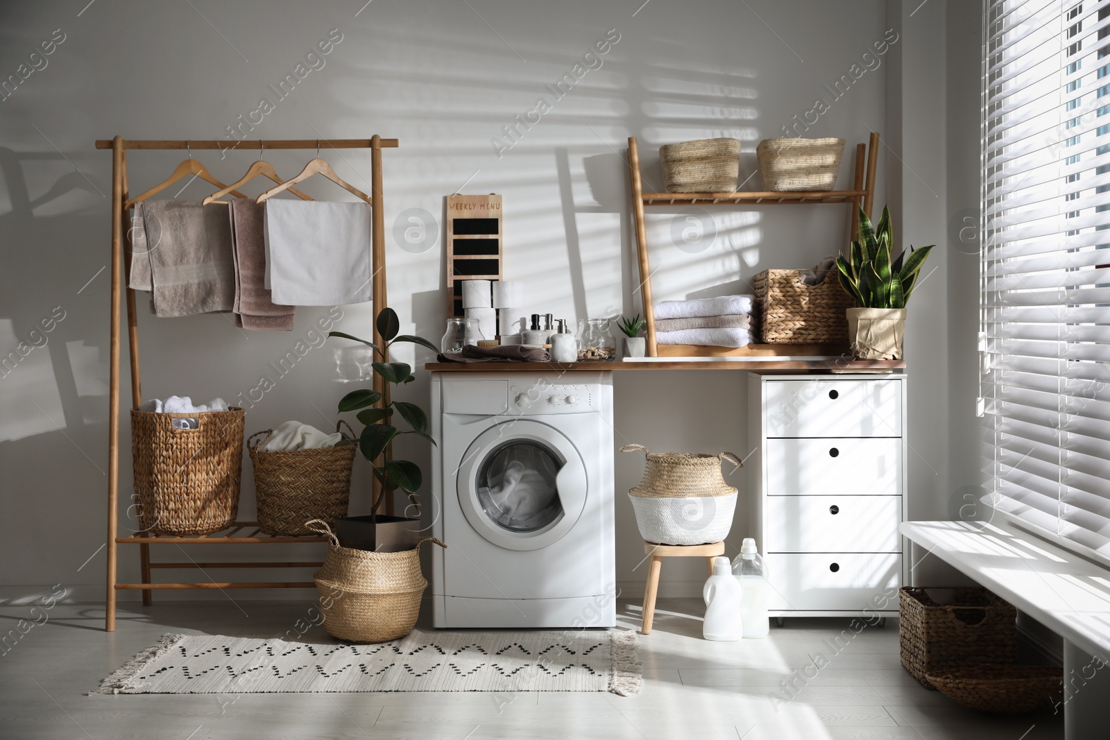 Photo of Stylish bathroom interior with modern washing machine