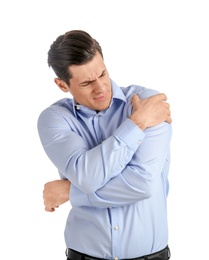 Young man suffering from pain in shoulder on white background