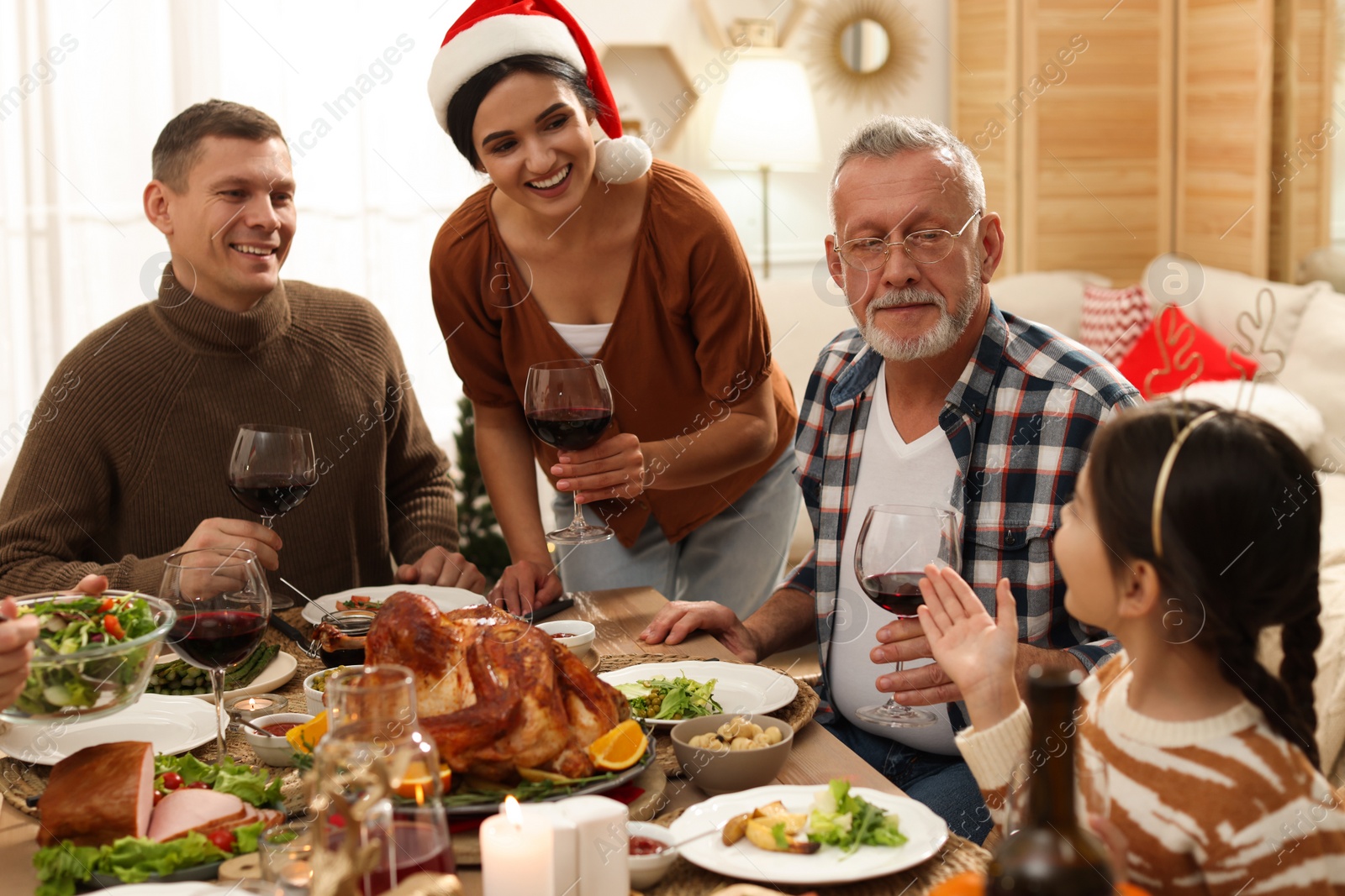 Photo of Happy family enjoying festive dinner at home. Christmas celebration