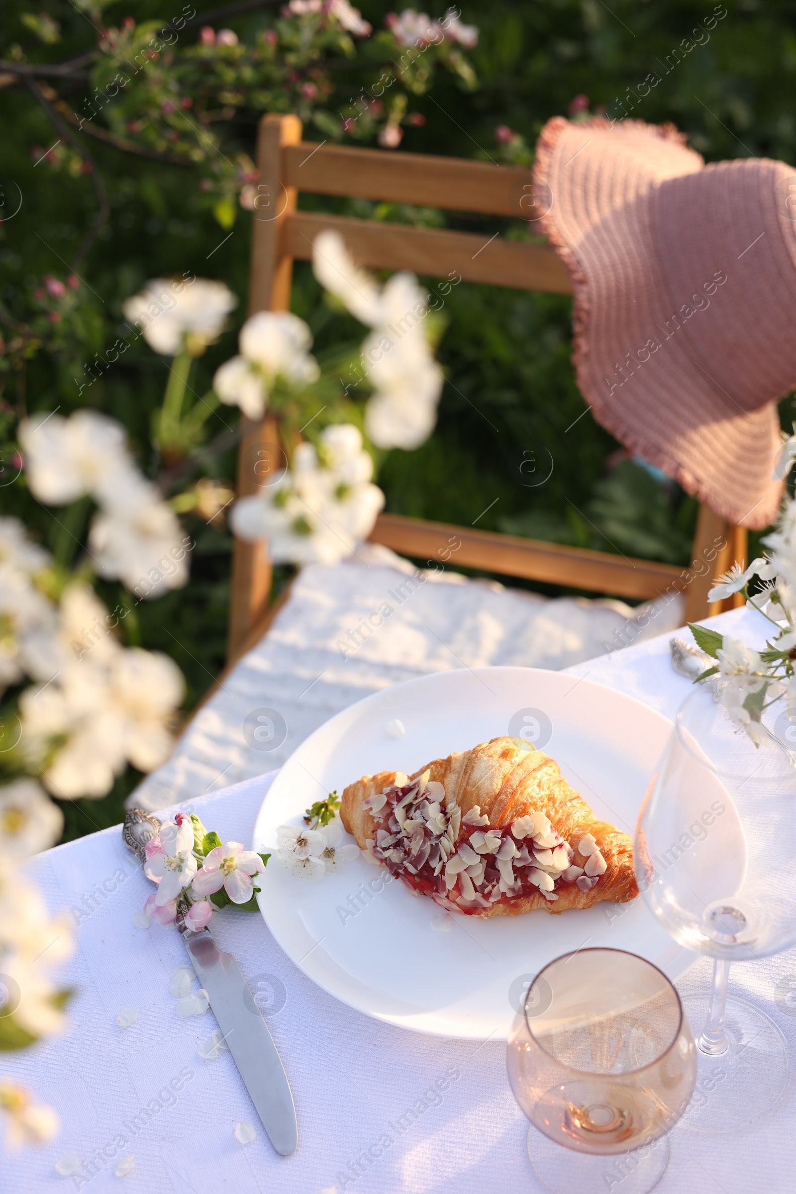 Photo of Stylish table setting with beautiful spring flowers in garden