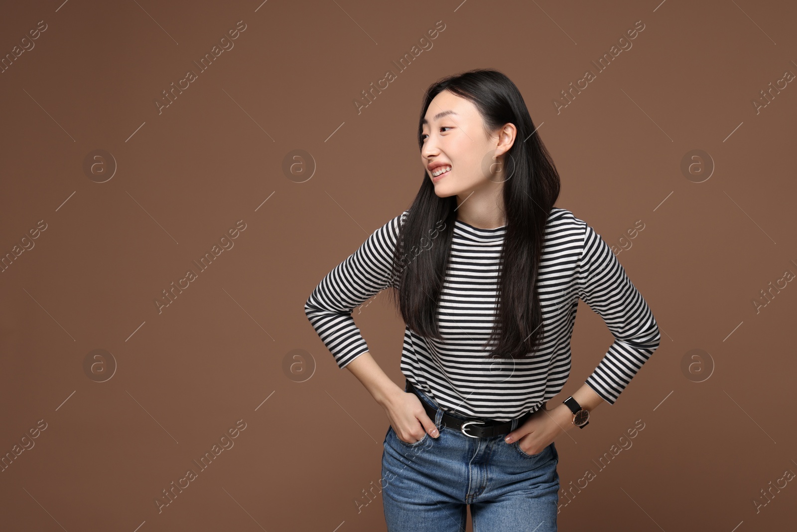 Photo of Portrait of smiling woman on brown background. Space for text
