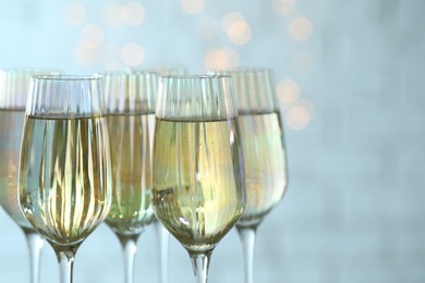 Photo of Glasses of champagne against blurred lights, closeup