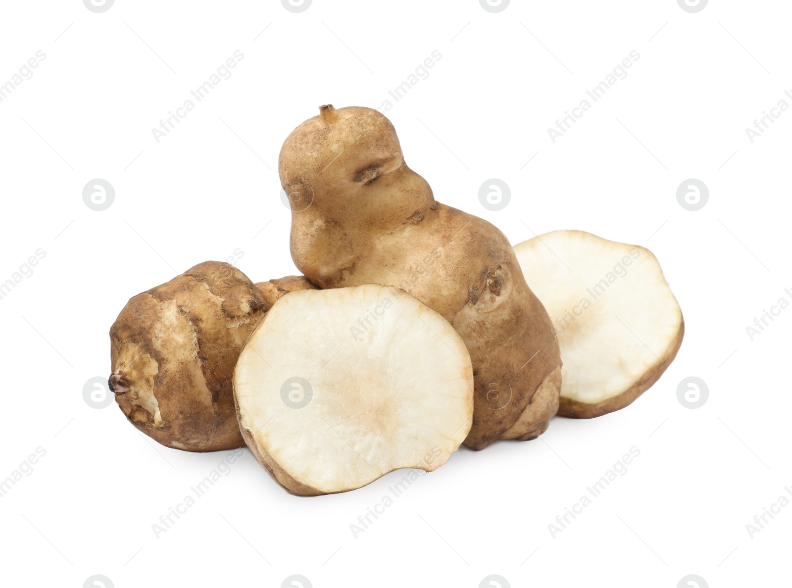 Photo of Whole and cut Jerusalem artichokes isolated on white