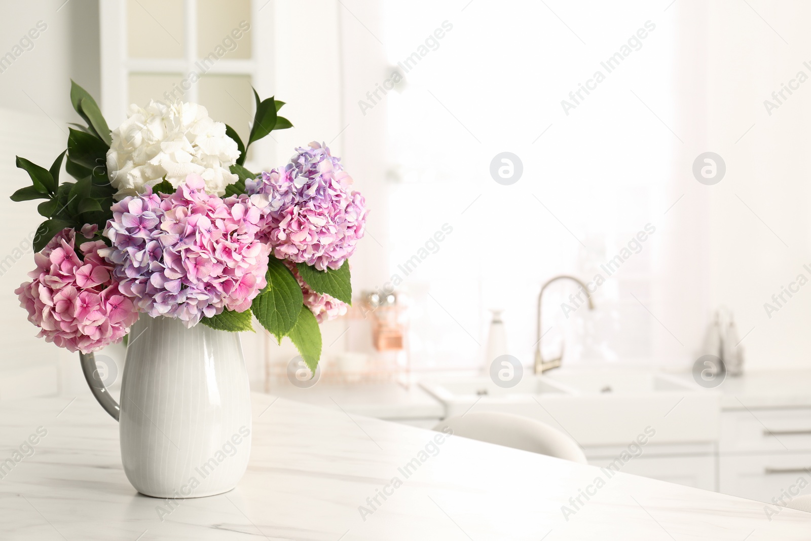 Photo of Bouquet with beautiful hydrangea flowers on white marble table. Space for text
