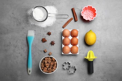 Cooking utensils and ingredients on grey table, flat lay