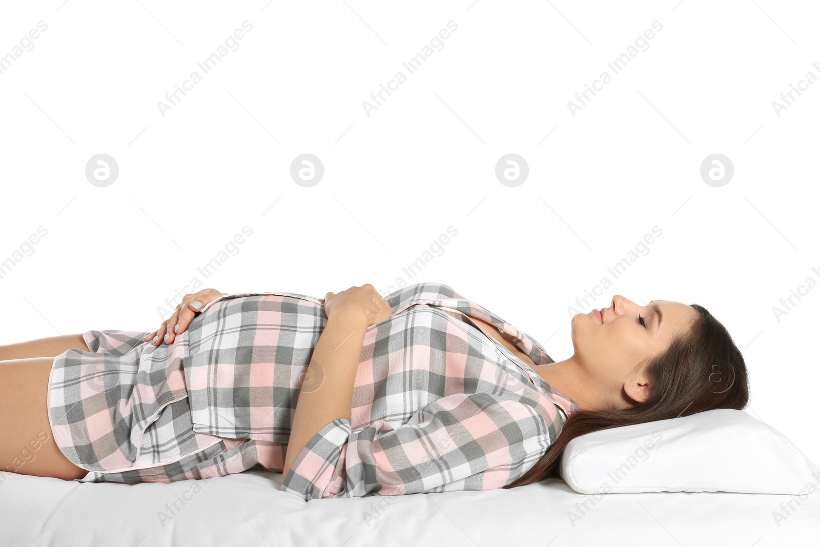 Photo of Beautiful pregnant woman sleeping with orthopedic pillow on bed against white background