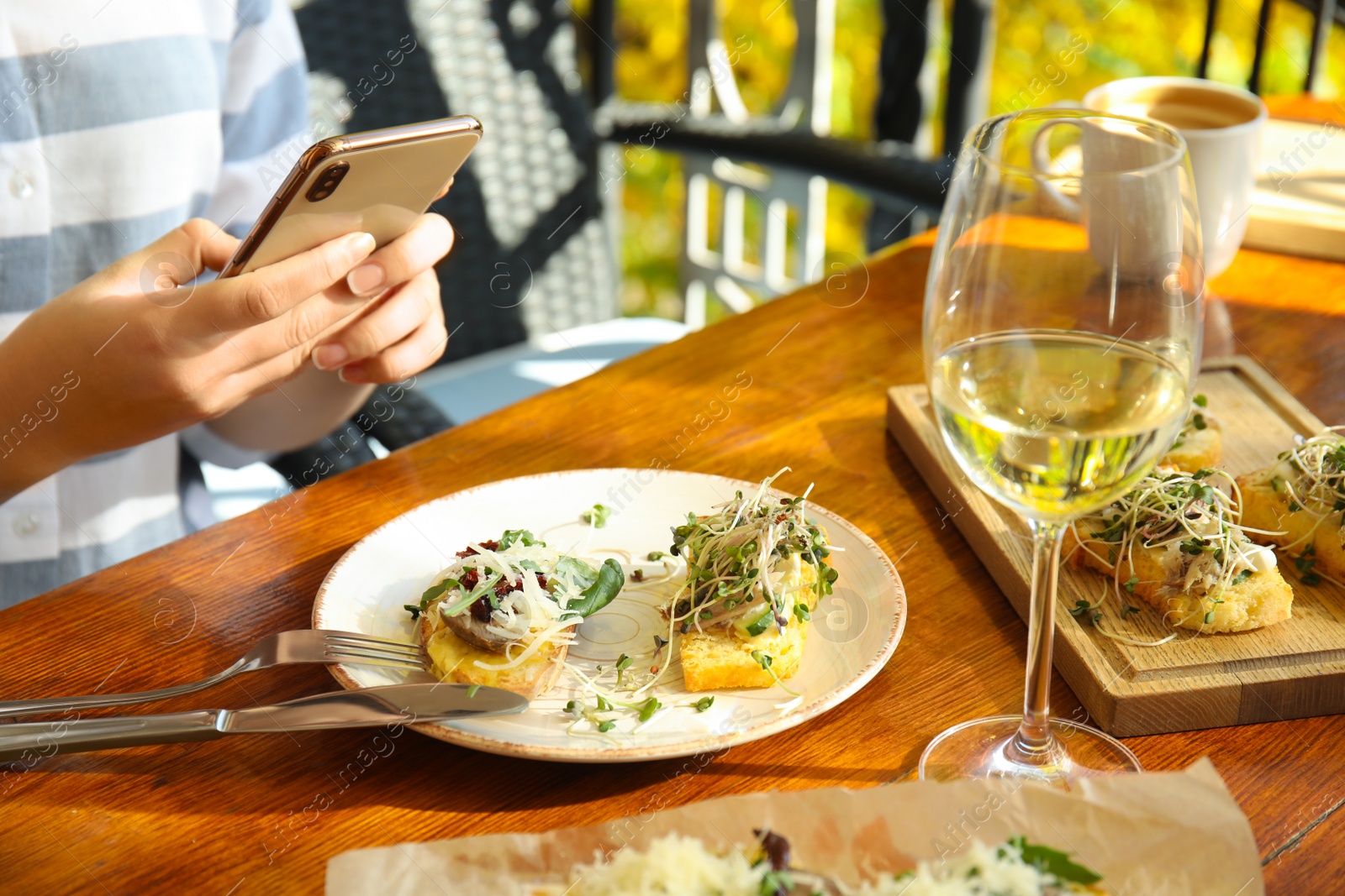 Photo of Food blogger taking photo of her lunch at cafe, closeup