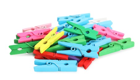 Pile of colorful wooden clothespins on white background