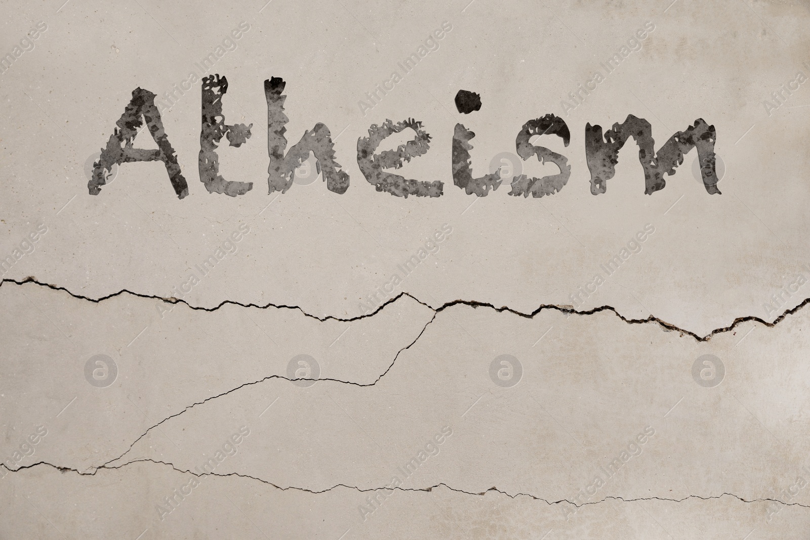 Image of Word Atheism on concrete surface, black ink style. Philosophical or religious position