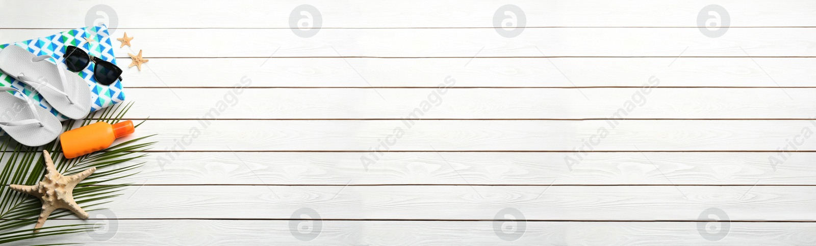 Photo of Beach accessories and space for text on white wooden background, flat lay. Banner design