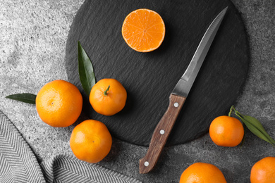 Photo of Fresh ripe tangerines on grey table, flat lay