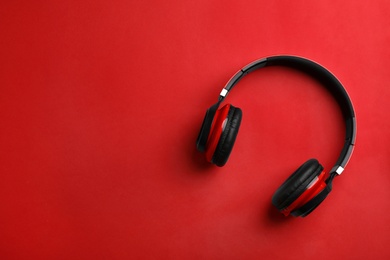 Photo of Wireless headphones on color background, top view. Space for text