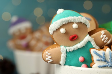 Photo of Delicious homemade Christmas cookies in bowl against blurred festive lights, closeup. Space for text