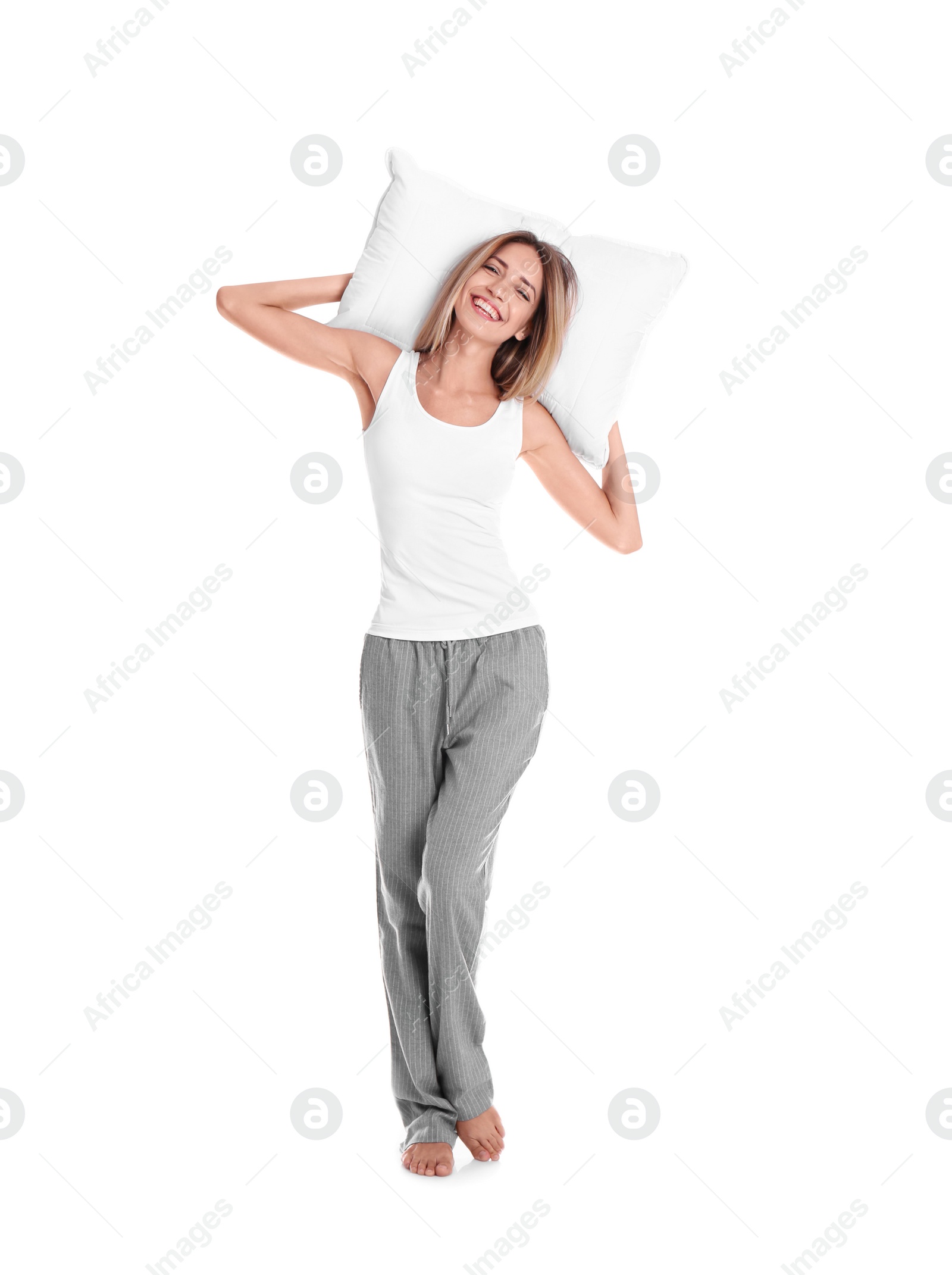 Photo of Happy woman in pajamas with pillow on white background