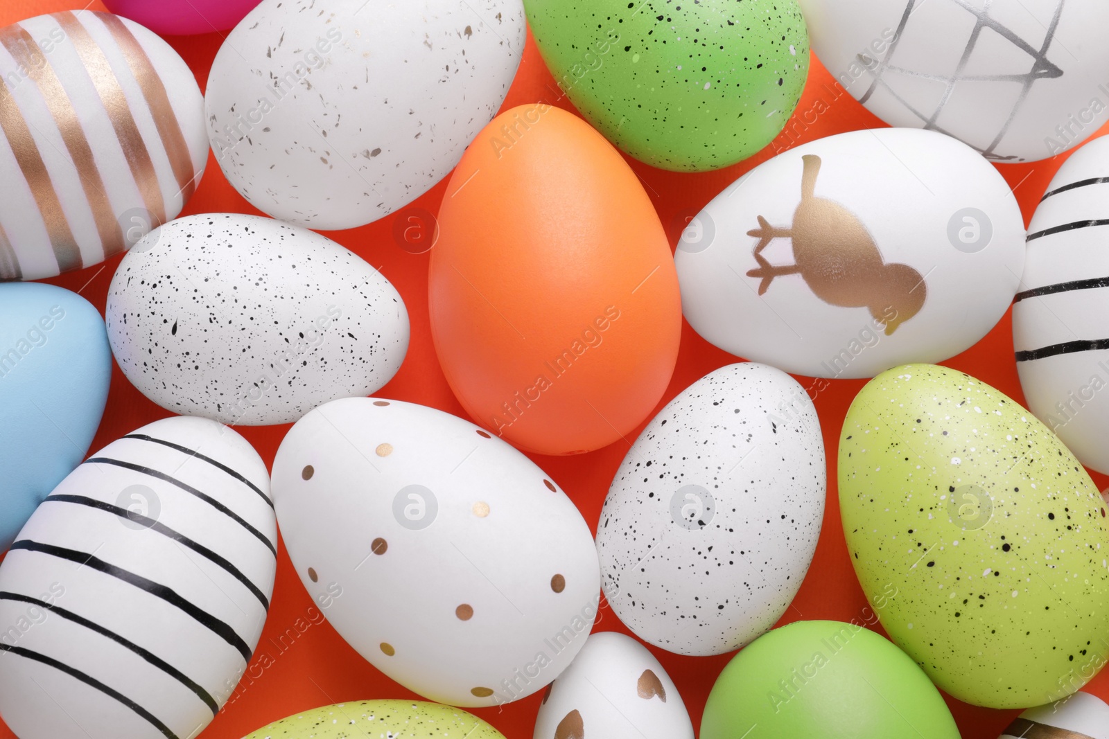 Photo of Beautifully painted Easter eggs as background, top view