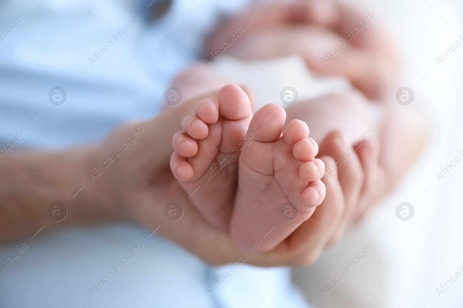 Photo of Father holding his newborn baby at home, closeup