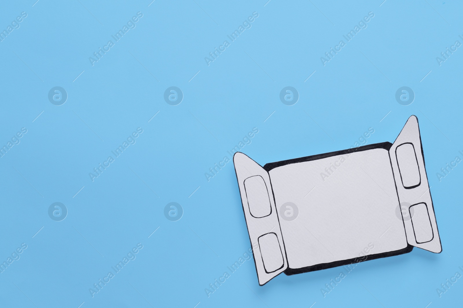 Photo of Open paper window frame on light blue background. Space for text