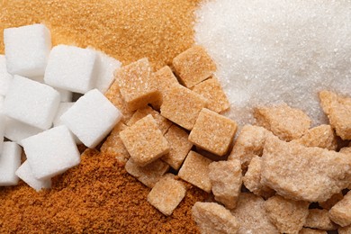 Photo of Different types of sugar as background, closeup
