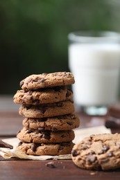 Photo of Delicious chocolate chip cookies on wooden table, closeup