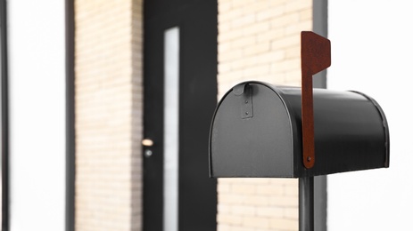 Photo of Black mailbox near house outdoors on sunny day