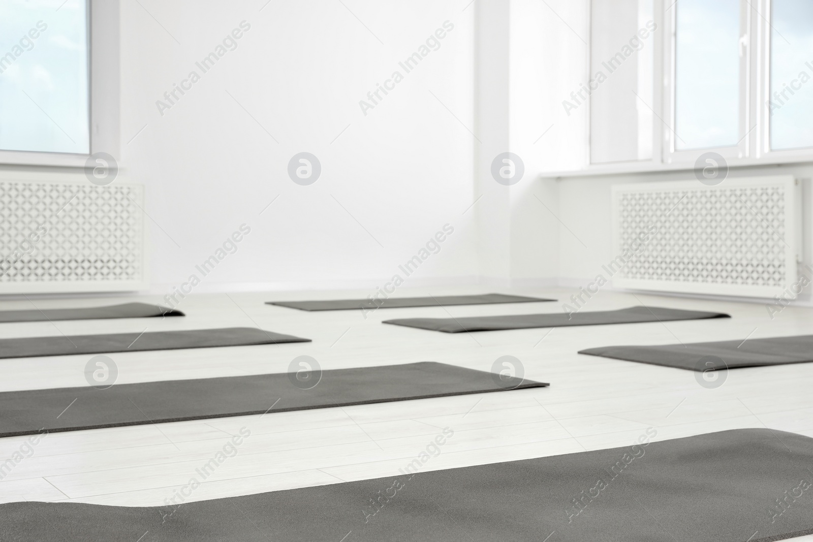 Photo of Spacious yoga studio with exercise mats on floor