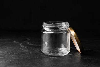 Photo of Empty glass jar on black stone table