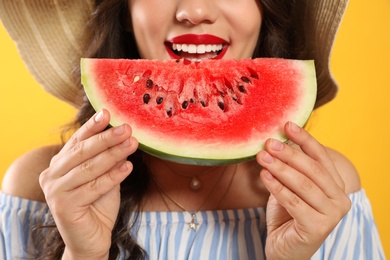 Photo of Beautiful young woman with watermelon on yellow background, closeup