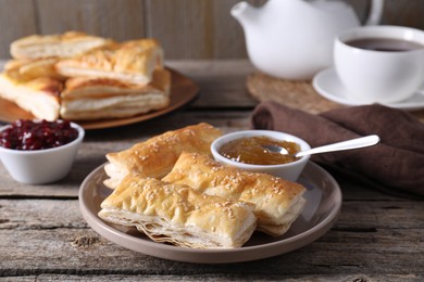 Photo of Delicious puff pastry served on wooden table