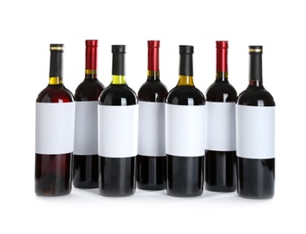 Photo of Bottles with red wine on white background